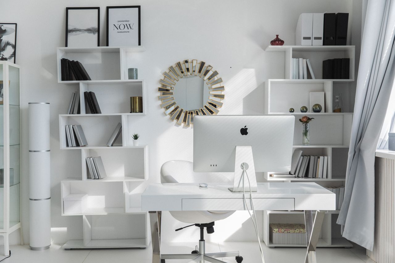 services-01 Bright minimalist home office setup with white shelves, desk, and iMac. Ideal for productivity.