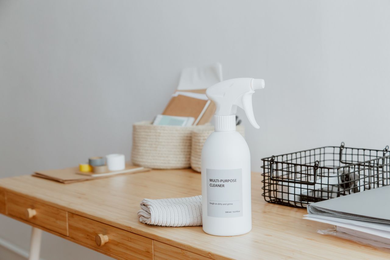 heros-img Minimalist desk with a focus on a multipurpose cleaner, office supplies, and storage solutions.